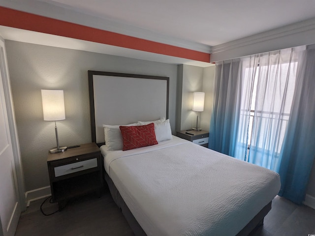 bedroom featuring wood-type flooring and multiple windows