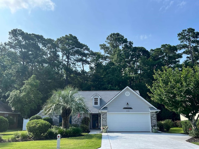 view of front of property with a garage and a front lawn