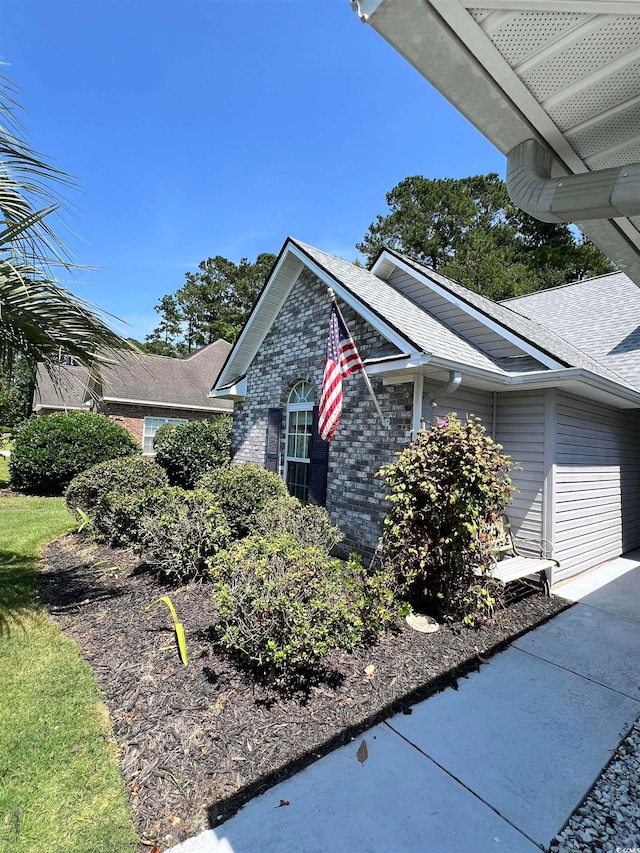 view of side of home featuring a garage