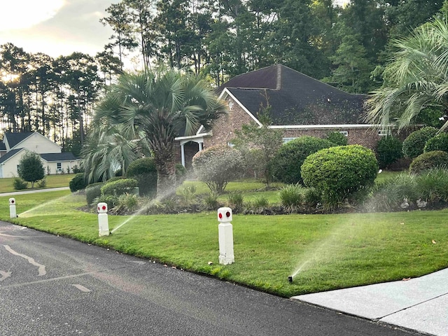 view of property's community with a lawn