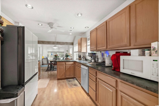 kitchen with ceiling fan, light hardwood / wood-style flooring, black fridge, vaulted ceiling, and dishwasher