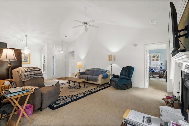 living room with carpet floors, ceiling fan, a high end fireplace, and high vaulted ceiling