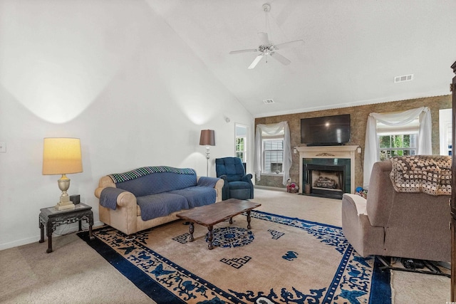 carpeted living room featuring ceiling fan, a fireplace, and high vaulted ceiling