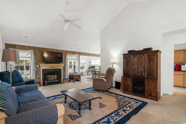 carpeted living room with high vaulted ceiling, ceiling fan, and a healthy amount of sunlight