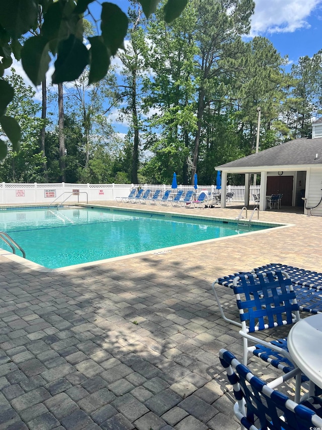 view of swimming pool featuring a patio area