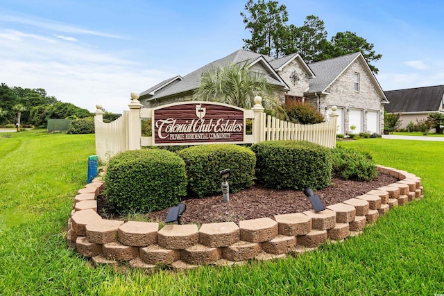 community sign with a lawn and a garage