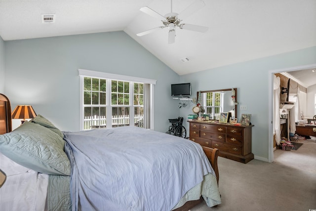 bedroom with high vaulted ceiling, ceiling fan, multiple windows, and light colored carpet