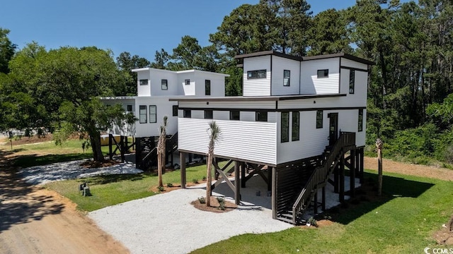 216 Brown Pelican Loop, Pawleys Island, SC 29585 - rear view of property with stairs, a lawn, a carport, and driveway