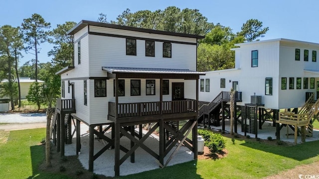 216 Brown Pelican Loop, Pawleys Island, SC 29585 - back of house featuring a yard, stairway, and metal roof