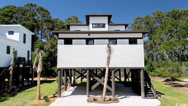 216 Brown Pelican Loop, Pawleys Island, SC 29585 - view of front of house with a carport, stairway, and a front lawn
