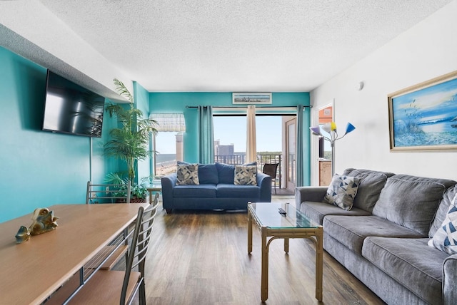 living room with hardwood / wood-style flooring and a textured ceiling