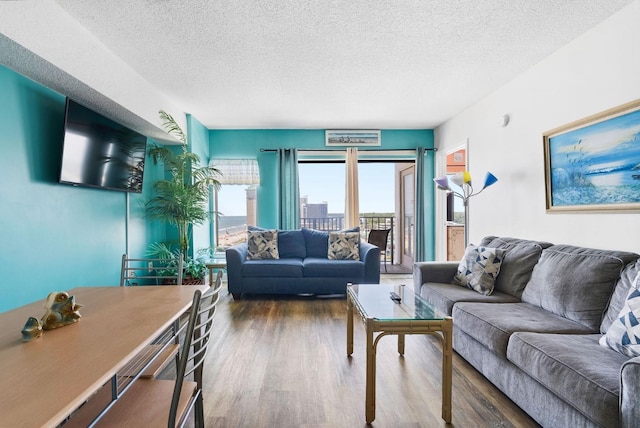 living room with a textured ceiling and wood finished floors