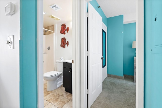 full bath featuring vanity, toilet, visible vents, and walk in shower