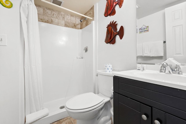 bathroom with vanity, toilet, and a shower stall