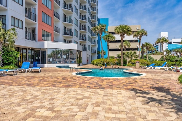 community pool with a patio area