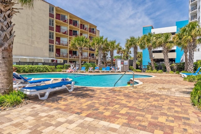 pool featuring a patio and fence