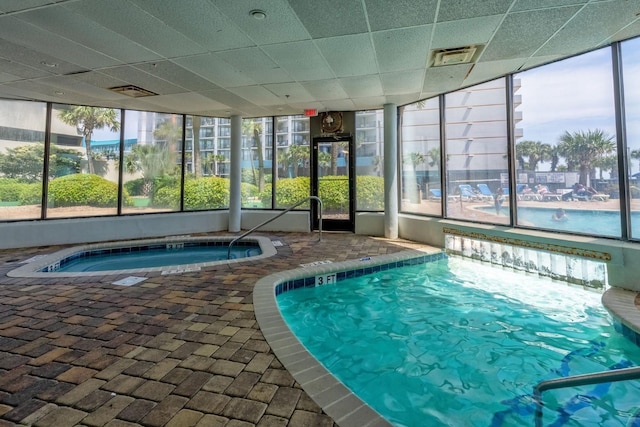 view of swimming pool with an indoor hot tub