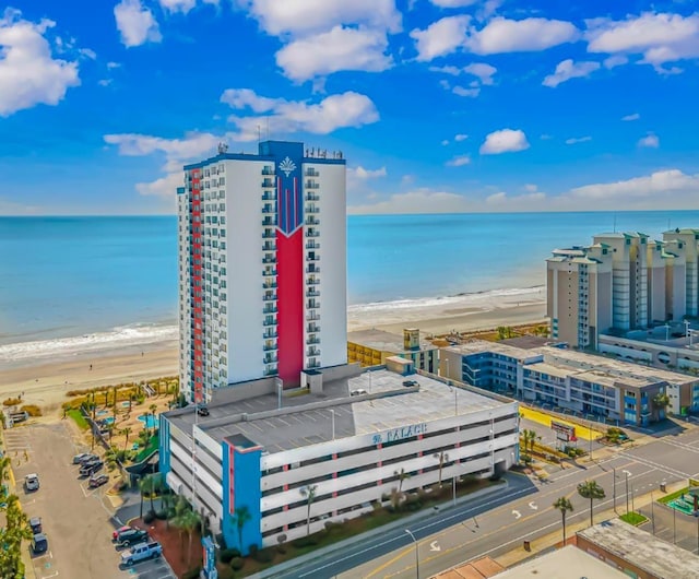 bird's eye view featuring a water view and a beach view