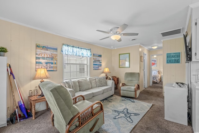 carpeted living room featuring ceiling fan and crown molding