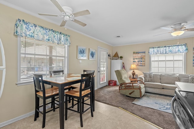 dining room featuring crown molding, ceiling fan, a healthy amount of sunlight, and light tile patterned floors