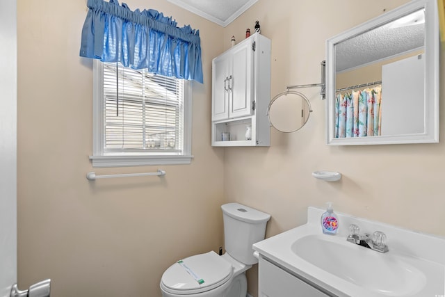 bathroom with vanity, toilet, and ornamental molding