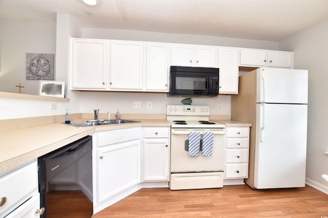 kitchen featuring white cabinets, light hardwood / wood-style floors, black appliances, and sink