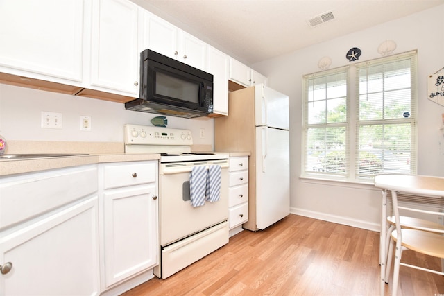 kitchen featuring white cabinets, white appliances, and light wood-type flooring