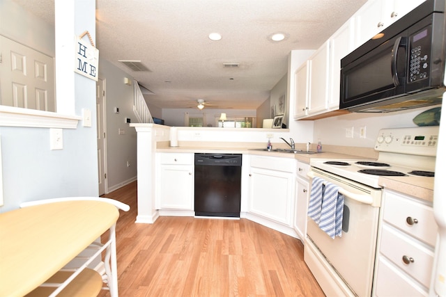 kitchen with black appliances, white cabinets, kitchen peninsula, light wood-type flooring, and ceiling fan