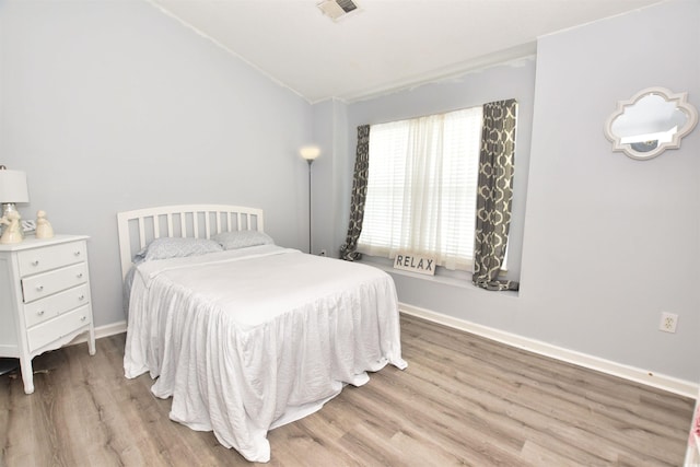 bedroom with wood-type flooring