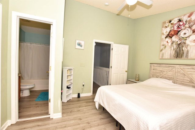 bedroom with a closet, a spacious closet, hardwood / wood-style flooring, ceiling fan, and ensuite bathroom