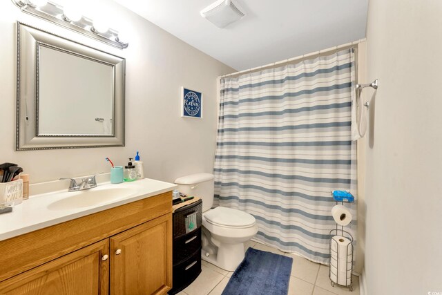 bathroom with tile patterned flooring, vanity, toilet, and curtained shower