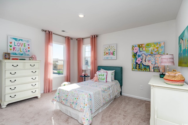 bedroom featuring light carpet