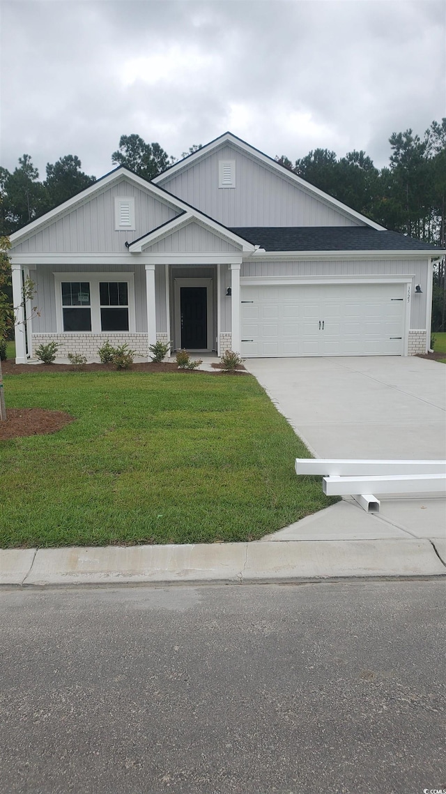 574 Tullimore Ln, Calabash, NC 28467 - view of front of home featuring a garage, concrete driveway, and a front yard
