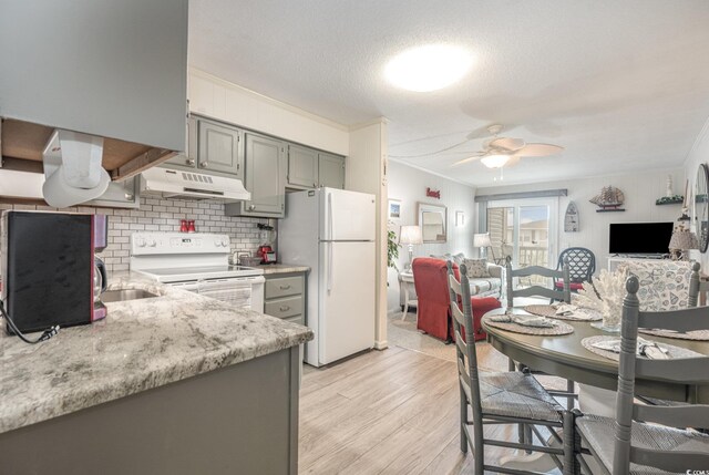 kitchen with backsplash, light hardwood / wood-style floors, crown molding, white appliances, and ceiling fan