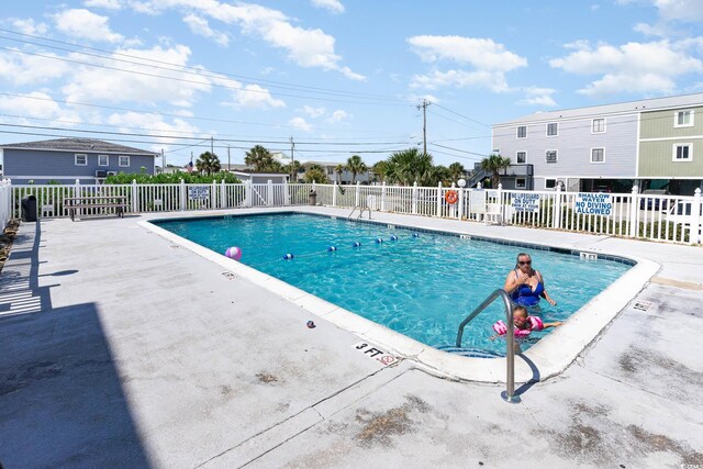 view of swimming pool featuring a patio area