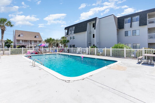 view of swimming pool with a patio area