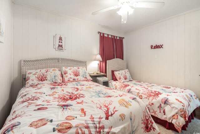 bedroom with ceiling fan and crown molding