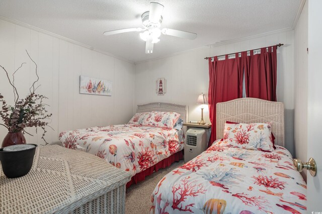 bedroom featuring ceiling fan, a textured ceiling, carpet, and crown molding