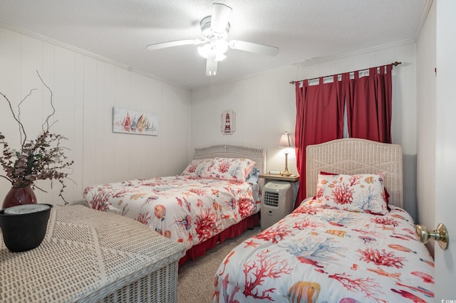 bedroom featuring carpet floors, ceiling fan, a textured ceiling, and crown molding