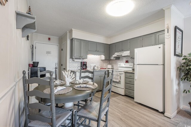 kitchen featuring gray cabinetry, white appliances, and decorative backsplash