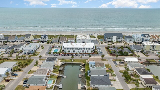 birds eye view of property with a beach view and a water view