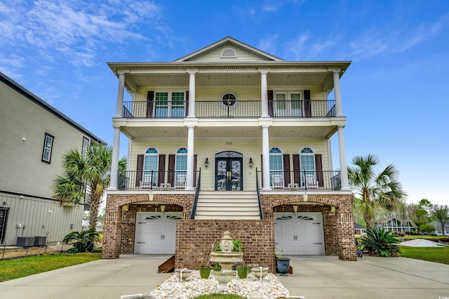 view of front of home with french doors, a garage, and central AC unit