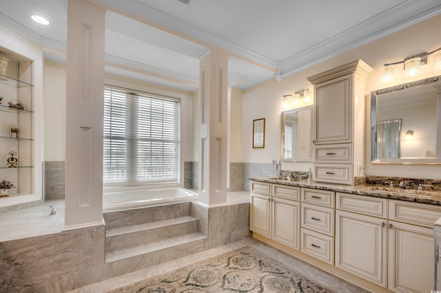 bathroom featuring vanity, crown molding, built in features, and a relaxing tiled tub