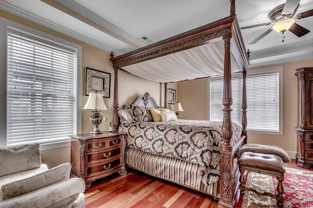 bedroom featuring ceiling fan, hardwood / wood-style flooring, and ornamental molding