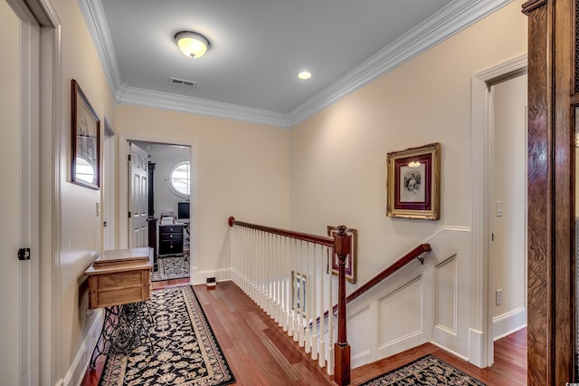 hall with wood-type flooring and crown molding