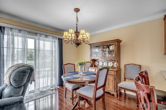 dining space featuring ornamental molding and a notable chandelier