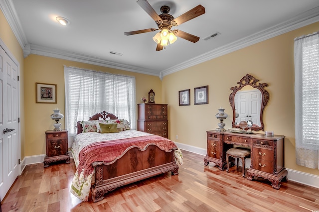 bedroom with light hardwood / wood-style flooring, ceiling fan, and crown molding