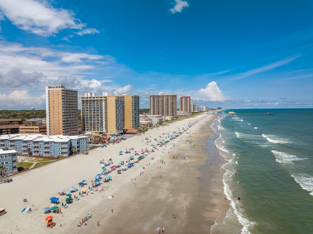 drone / aerial view with a water view and a beach view