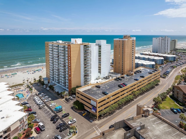 drone / aerial view featuring a water view and a view of the beach