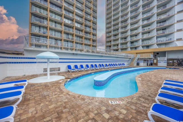 view of pool at dusk